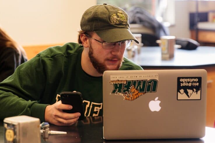 UMFK GIS student working on their laptop in the science lab.