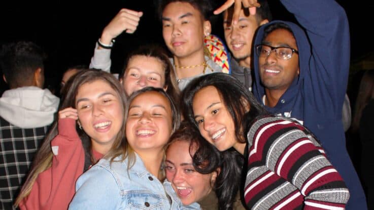 a diverse group of students hanging out and having fun at a student event