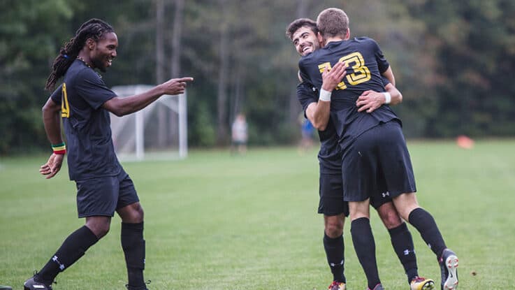 Two soccer players hug after an impressive play