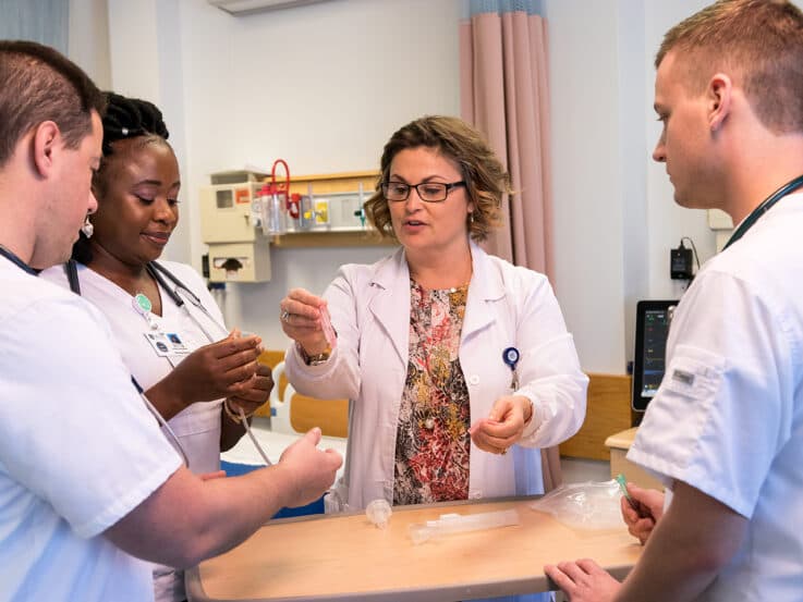 UMFK Nursing faculty Sandy Pelleter instructs students during their lab course.