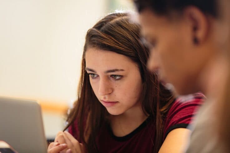 UMFK Student working on a project with another student