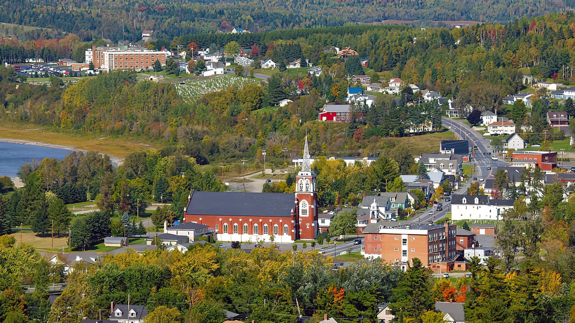 aerial photo of East Main Street in Fort Kent showing the local Catholic church and several business and residential buildings