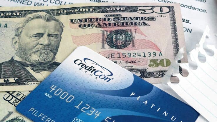 a closeup of a fifty dollar bill and a credit card