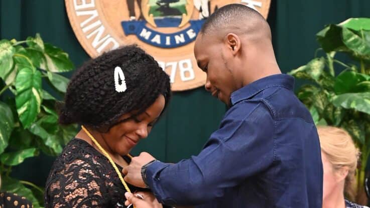 a female nursing graduate receives her nursing pin during a pinning ceremony