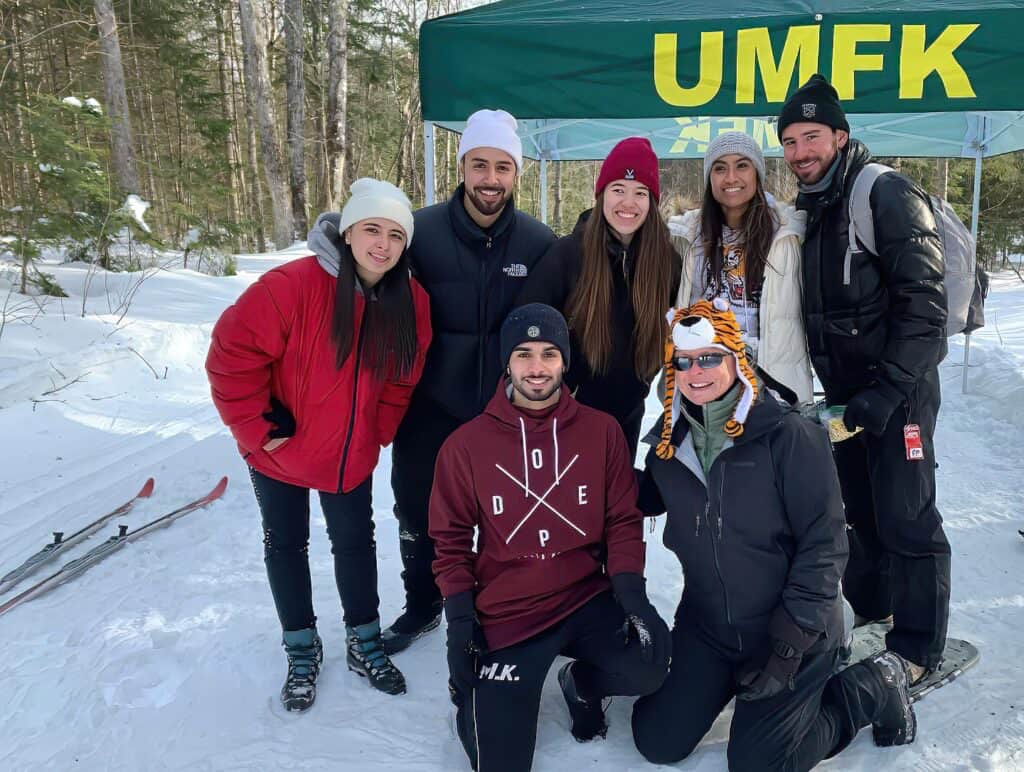 a group of students at a cross country ski event with UMFK president