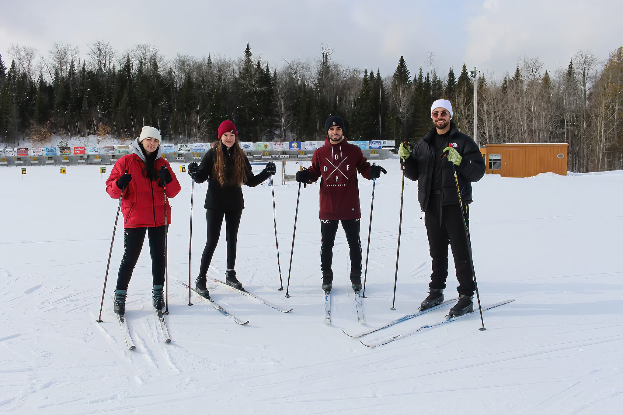 four cross country skiers pose