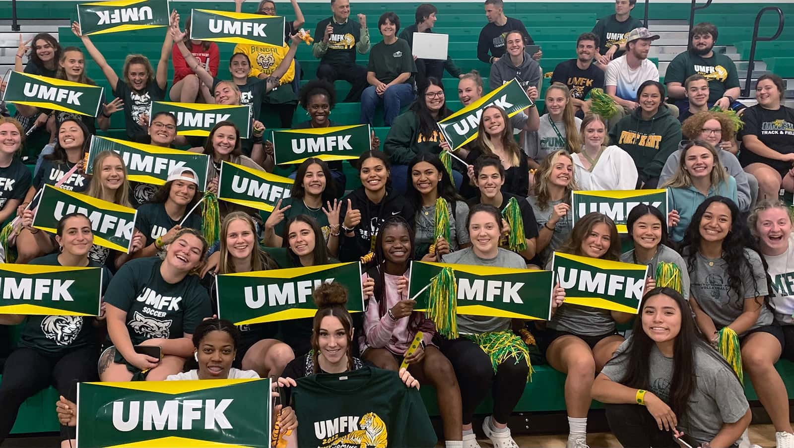 UMFK photo with students holding UMFK swag at the Sports Center