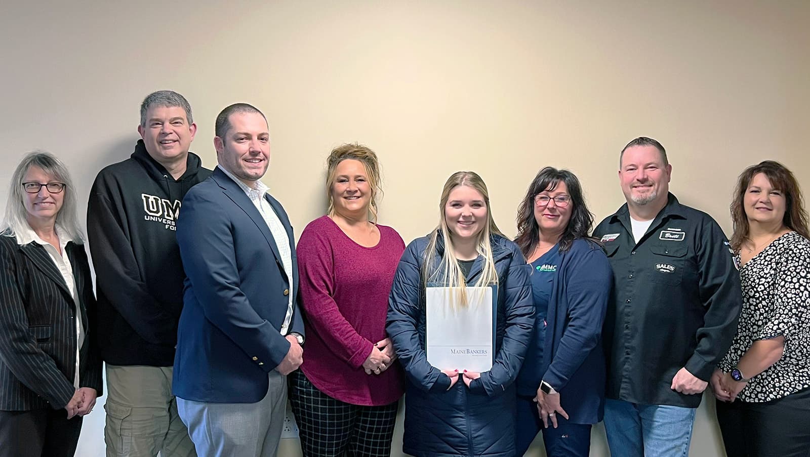 UMFK staff members and MeHEAF representatives present Julia Labbe with her scholarship