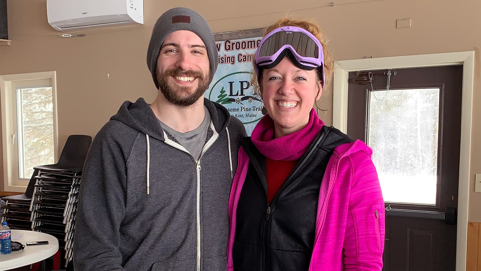 a smiling couple poses inside the Lonesome Pine ski lodge