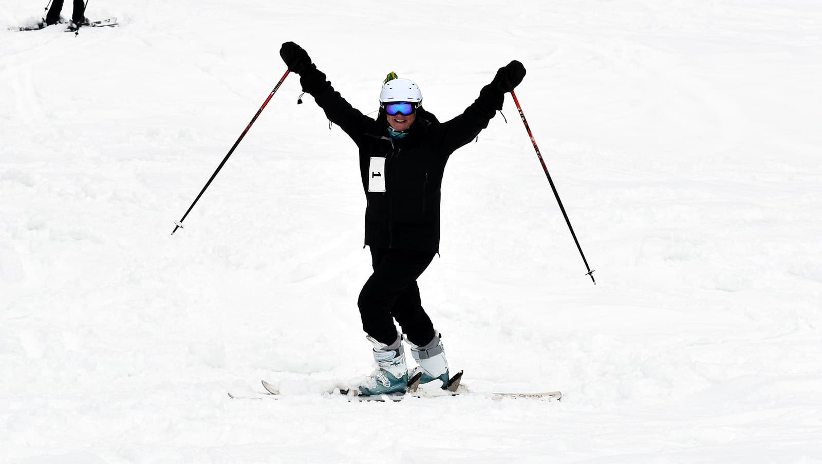 UMFK President Hedeen cheers at the end of her downhill ski run