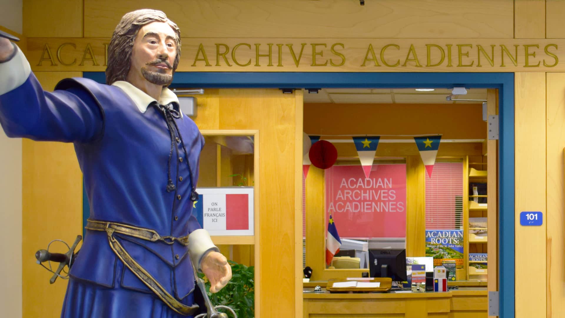 entrance to the Acadian Archives with a statue of Samuel de Champlain in the foreground