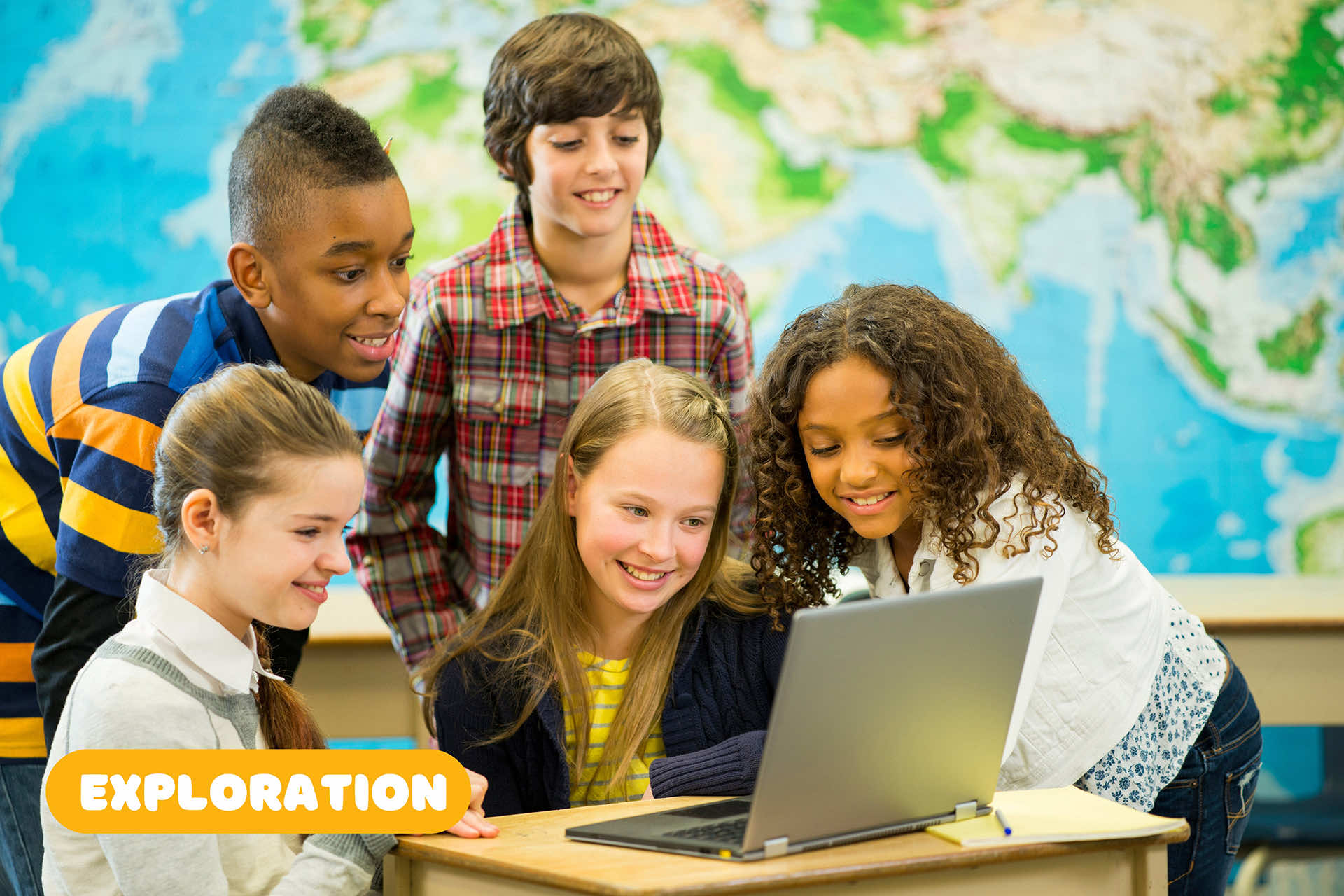 kids gathered around a laptop in a classroom