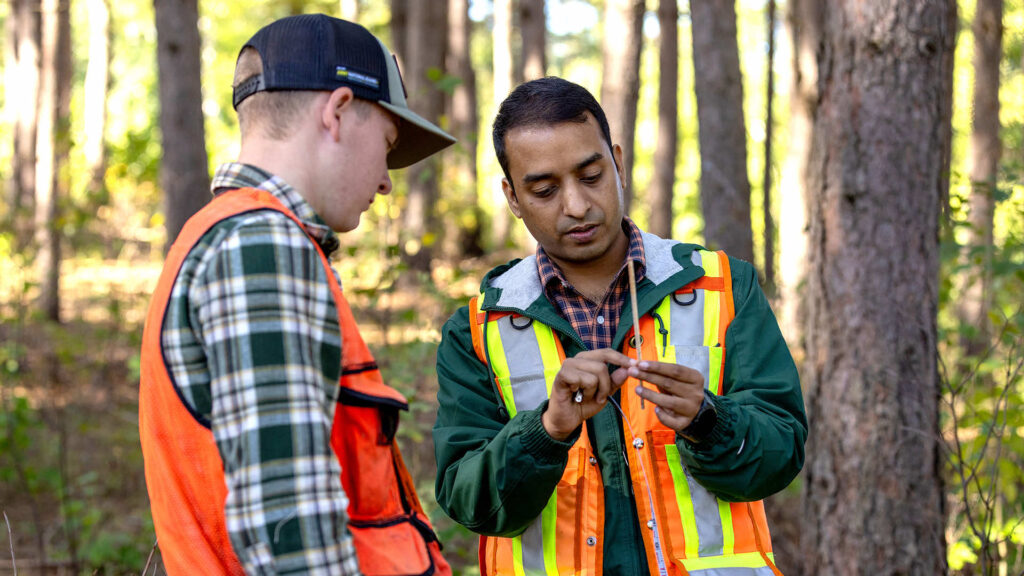 USDA Research Grant 1 a UMFK forestry student and Libin Thaikkattil Louis in the forest